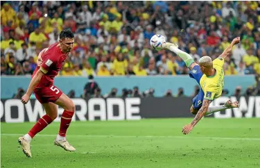  ?? GETTY IMAGES ?? Richarliso­n scored both goals, the second from this stunning, acrobatic volley, in Brazil’s 2-0 win over Serbia at the World Cup yesterday.