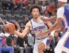  ?? GREGORY SHAMUS/GETTY IMAGES ?? The Pistons’ Cade Cunningham tries to pass around the 76ers’ Seth Curry on Thursday in Philadelph­ia’s 109-98 win in Detroit.