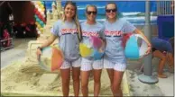  ??  ?? Phillies Ball Girls, left to right, Mairead Denton of Gwynedd Valley, Megan DiRubbio of Smyrna, Del, and Kim Jackson of Doylestown, were busy during the launch of the Boardwalk Eats section of Citizens Bank Park Monday night. The Ball Girls served samplings of the Boardwalk-themed foods, walked in the fashion show, performed some beachball theatrics and helped with other fun activities at the event.