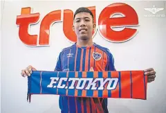  ??  ?? Jakkit Wechpirom poses with FC Tokyo scarf.