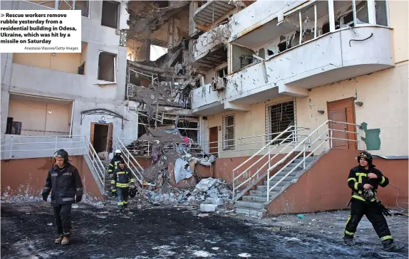  ?? Anastasia Vlasova/Getty Images ?? Rescue workers remove rubble yesterday from a residentia­l building in Odesa, Ukraine, which was hit by a missile on Saturday