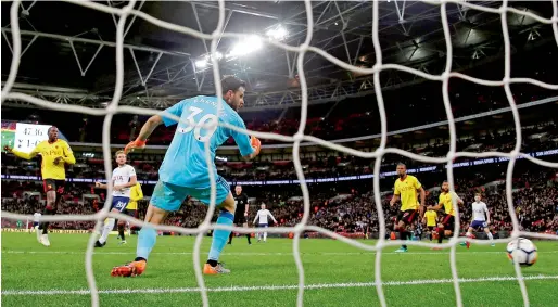  ?? Reuters ?? Harry Kane scores Tottenham’s second goal during their English Premier League match against Watford on Monday. —