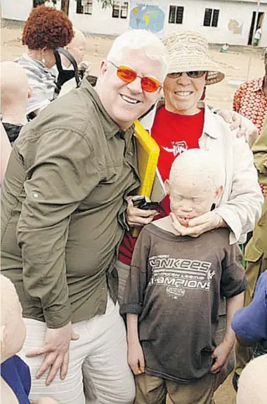  ??  ?? Surrey businessma­n Peter Ash, left, founded the charity Under the Same Sun. Ash is shown here with Al- Shaymaa Kwegyir of Tanzania, who also has albinism, and a boy with albinism in northern Tanzania’s Lake Victoria district.