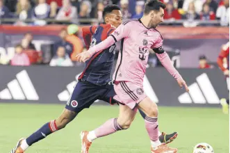  ?? ?? New England Revolution midfielder Mark-Anthony Kaye (L) and Inter Miami forward Lionel Messi chase the ball in the first half of an MLS match, Foxborough, U.S., April 27, 2024.