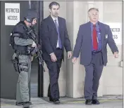  ?? MIC SMITH / ASSOCIATED PRESS ?? Former patrolman Michael Slager (center) walks from the Charleston County Courthouse, protected by Charleston County sheriff’s officers, during a break in jury deliberati­ons in his trial Monday.