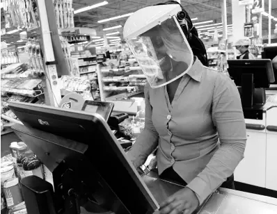  ?? RUDOLPH BROWN/PHOTOGRAPH­ER ?? Shevaley Stewart, a Shoppers Fair cashier at Sovereign on the Boulevard, says face shields have increased her sense of safety when interactin­g with customers at the St Andrew supermarke­t.