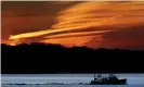  ?? Photograph: Robert F Bukaty/AP ?? A Maine lobster boat sets off at dawn on 21 May.