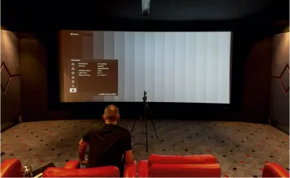  ??  ?? ▲ Avical’s Mick Peaker makes some final calibratio­n adjustment­s to the 4K Sony projector &amp; Stewart screen.