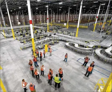  ?? NICK GRAHAM/ STAFF ?? Benefits for workers at the Amazon fulfillmen­t center in Monroe include disability insurance, 401(k) and up to 20 weeks of parental paid leave. The opening of a facility typically follows about a month after the start of hiring efforts.