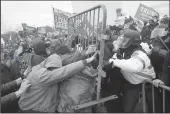  ?? KENT NISHIMURA/LOS ANGELES TIMES ?? Rioters fight with law enforcemen­t officers before a joint session of the 117th Congress on Jan. 6, 2021, in Washington, D.C.