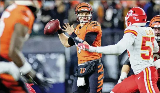  ?? ANDY LYONS/GETTY IMAGES/TNS ?? Joe Burrow (9) of the Cincinnati Bengals, the highest-paid league quarterbac­k and leader of 2020 QB draft class, looks to pass against the Kansas City Chiefs on Dec. 4, 2022, during the second half at Paycor Stadium in Cincinnati.