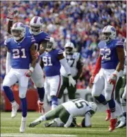  ?? ADRIAN KRAUS — ASSOCIATED PRESS ?? Bills’ Jordan Poyer celebrates with teammates after sacking Jets quarterbac­k Josh McCown during Buffalo victory on Sunday.