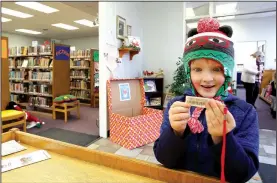  ?? NWA Democrat-Gazette/DAVID GOTTSCHALK ?? Hudson Cantu, 6, admires his very first library card Thursday at the Doris Sharp Children’s Library in Prairie Grove. The city is purchasing the former Walmart Express building and plans to move the library and children’s library into it.