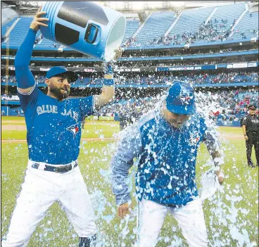  ?? PHOTOS BY VERONICA HENRI/POSTMEDIA ?? Following the Blue Jays’ win over the Houston Astros yesterday, outgoing manager John Gibbons was treated to a Gatorade shower by outfielder Kevin Pillar. With the Jays and the popular Gibbons parting ways at the end of the season, the manager acknowledg­ed the crowd often and received multiple standing ovations.