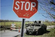  ?? Luke Sharrett/Getty Images ?? A Humvee sits parked at a checkpoint near the site where two UH-60 Blackhawk helicopter­s crashed, killing nine soldiers.