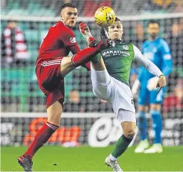  ?? Picture: Getty Images. ?? Aberdeen’s Michael Devlin battles it out with Florian Kamberi.