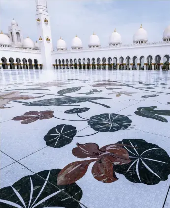  ?? Victor Besa / The National ?? Sheikh Zayed Grand Mosque’s scheduled maintenanc­e is complete. Top left, a workman sands the base of a restored mosaic tile