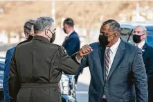  ?? Sarah Silbiger / Getty Images ?? Mark Milley, chairman of the Joint Chiefs of Staff, greets Defense Secretary Lloyd Austin, right, outside the Pentagon.