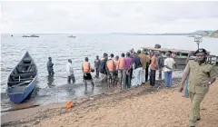  ?? REUTERS ?? Rescuers gather at the shores of Lake Victoria searching for bodies of dead passengers after a cruise boat capsized in Mukono district on Saturday.