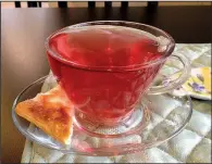  ?? Arkansas Democrat-Gazette/JENNIFER NIXON ?? Tea orders at Abbi’s Teas &amp; Things, like this cup of the custom blend Blueberry Lemongrass, come with a bite of sweet flaky pastry.