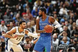  ?? DAVID ZALUBOWSKI / ASSOCIATED PRESS ?? Nuggets guard Jamal Murray (27) and Thunder forward Paul George square offduring a game in Denver. George could remain in Oklahoma City next season but has yet to give word on his future.