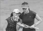  ?? AP ?? China’s Duan Yingying (right) and Zheng Saisai talk tactics prior to serving against Hungary’s Timea Babos and Kristina Mladenovic of France during Sunday’s women’s doubles final at the French Open.