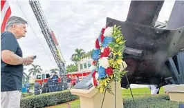  ?? FILE PHOTOS ?? James Holmes, of Wellington, reads the plaque that describes the origins of one of the largest steel beams recovered from the World Trade Center after the 9/11 attacks and is now displayed at Wellington’s Patriot Memorial.