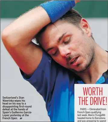  ?? AP ?? Switzerlan­d’s Stan Wawrinka wipes his head on his way to a disappoint­ing first-round defeat at the hands of Spain’s Guillermo GarciaLope­z yesterday at the French Open.