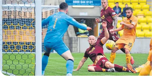  ??  ?? Motherwell forward Curtis Main passes up a chance to score past Livingston’s man of the match Liam Kelly yesterday