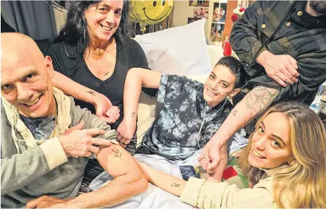  ?? ?? Janice and her family, (clockwise from left) father Michael Ipsan, brother Will (arm only), mother Stacey, husband Higginboth­am and sister Meredith – show off their matching olive branch tattoos on Thursday in Annandale.