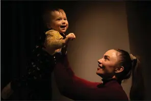  ?? (AP/Vadim Ghirda) ?? Yeva, a Ukrainian toddler who was born on Feb. 24, 2022, plays with her mother, Alina Mustafaiev­a, on Feb. 17 at their home in Kharkiv, Ukraine.