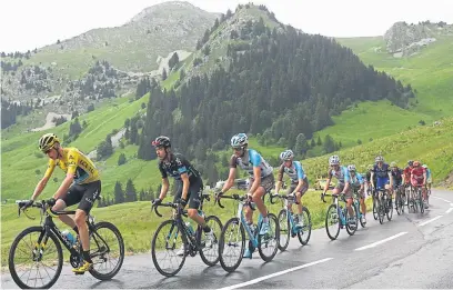  ??  ?? Chris Froome, front, leads the way to Morzine in the mountains