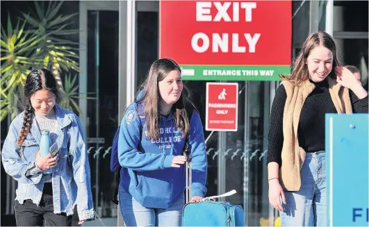  ?? PHOTO: CHRISTINE O’CONNOR ?? Beginning of the return . . . University of Otago student Megan Clark (centre), of Blenheim, is picked up from Dunedin Airport on Saturday by fellow students Bonnie Feng (left) and Caitlin Li Calsi (right), who remained in Dunedin during the lockdown. Students are returning to Dunedin following New Zealand’s move into Alert Level 2, which allows tertiary education institutio­ns to resume lectures under strict conditions.