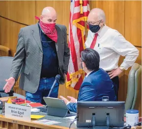  ??  ?? House Minority Whip Rod Montoya, R-Farmington, and House Minority Leader James Townsend, R-Artesia, talk with House Speaker Brian Egolf, D-Santa Fe, during debate over a civil rights bill in the House on Tuesday.