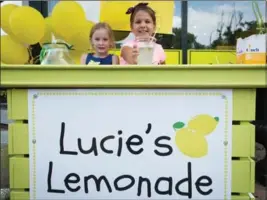  ?? VANESSA TIGNANELLI, RECORD STAFF ?? Seven-year-old Lucie Freiburger (right) hands out a cup of lemonade with her friend Chloe Cross. Lucie raised $4,000 this summer for KidsAbilit­y, from her weekly lemonade stand at the Culinary Studio in Waterloo. Philanthro­py expert Roger Ali writes:...