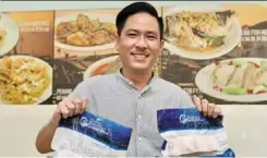  ?? ?? Chia holding the frozen Sabah giant grouper fish that he imports from the state for his ara damansara eatery.