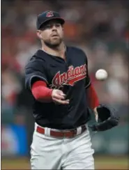  ?? RON SCHWANE — THE ASSOCIATED PRESS ?? Indians starting pitcher Corey Kluber throws out the Tigers’ Alex Presley at first base during the fourth inning.