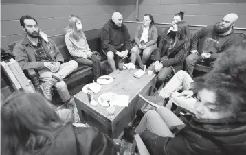  ?? KEITH SRAKOCIC/AP ?? Lt. Gov. John Fetterman, center, chats with fellow Democrats this month during a campaign stop at the Mechanisti­c Brewery in Clarion, Pennsylvan­ia. Fetterman is a leading candidate in the state’s high-stakes Senate contest.