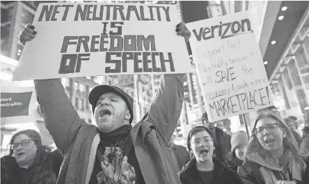  ?? MARY ALTAFFER/AP ?? People in New York City demonstrat­e in support of the current Net-neutrality regulation­s last Thursday.