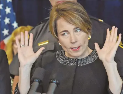  ?? STAFF PHOTOS BY PATRICK WHITTEMORE ?? ‘HOW DO YOU PUT A PRICE ON LIFE?’: Massachuse­tts Attorney General Maura Healey, above, speaks to the media yesterday after initiating a suit against Purdue Pharmaceut­icals. Below, A partial list of names on a poster referencin­g opioid-related overdoses.