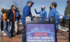  ?? JOHN MINCHILLO — THE ASSOCIATED PRESS ?? Fans arrive for COVID-19screenin­gs before entering Citi Field before the Mets’ home opener on Tursday in New York.