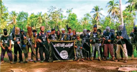  ??  ?? Members of the Philippine jihadist group pose for propaganda photo in this screen shot taken from the website of the Islamic State.