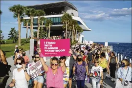  ?? LUIS SANTANA/TAMPA BAY TIMES/TNS 2021 ?? Hundreds gather to support abortion rights Oct. 2, 2021, in St. Petersburg, Florida. The march was one of several events in Tampa Bay and the nation protesting for abortion rights with the Women’s March group. A proposed six-week ban would move Florida closer to what other Gop-led states have done on abortion.