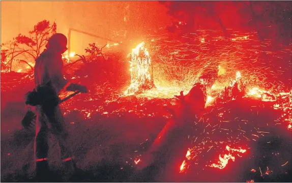  ?? NOAH BERGER — THE ASSOCIATED PRESS ?? Embers fly from a tree stump as the Creek Fire burns in the Cascadel Woods neighborho­od of Madera County on Monday.