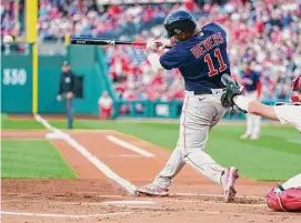  ?? Chris Szagola/Associated Press ?? The Boston Red Sox's Rafael Devers hits a single during the first inning against the Philadelph­ia Phillies on May 5 in Philadelph­ia.