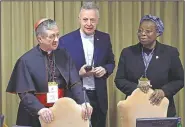  ?? AP/ALESSANDRA TARANTINO ?? Sister Veronica Openibo, a prominent Nigerian nun, talks with Chicago Archbishop and Cardinal Blase J. Cupich (left) and the Rev. Tomas Mavric at the Vatican on Saturday. Openibo spoke out against the culture of silence that has covered up clergy sexual abuse for so long.