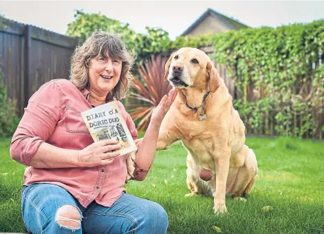  ??  ?? SHAGGY DOG STORIES: Elizabeth McAlpine, her dog Alfie and a copy of their new book. Picture by Jason Hedges.