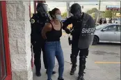  ?? PHOTO COURTESY KATIE AKIN ?? Police officers are shown arresting Des Moines Register reporter Andrea Sahouri after a Black Lives Matter protest she was covering on in Des Moines, Iowa, was dispersed by tear gas.