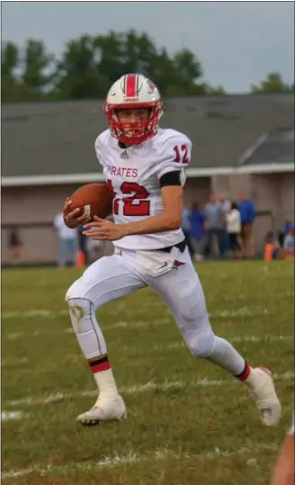  ?? COLEEN MOSKOWITZ — THE NEWS-HERALD ?? Perry quarterbac­k Drew Schiano carries against Madison during Week 3 this season.