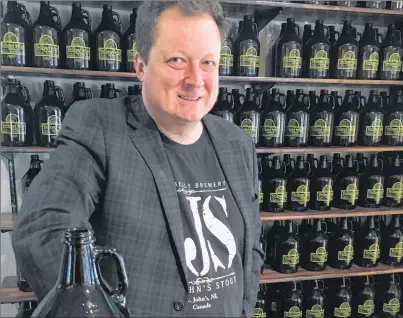 ?? KENN OLIVER/THE TELEGRAM ?? Co-owner Craig Flynn says they sold over 200 growlers of beer in the first week of business at the new Yellowbell­y Takeaway at 264 Water St. Also available at the retail side of the fully licensed takeout are Yellowbell­y brand shirts, sweaters and...
